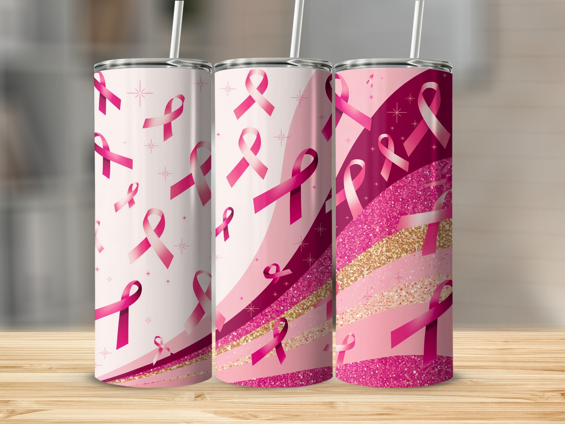 Three pink ribbon patterned tumblers with gold glitter accents.