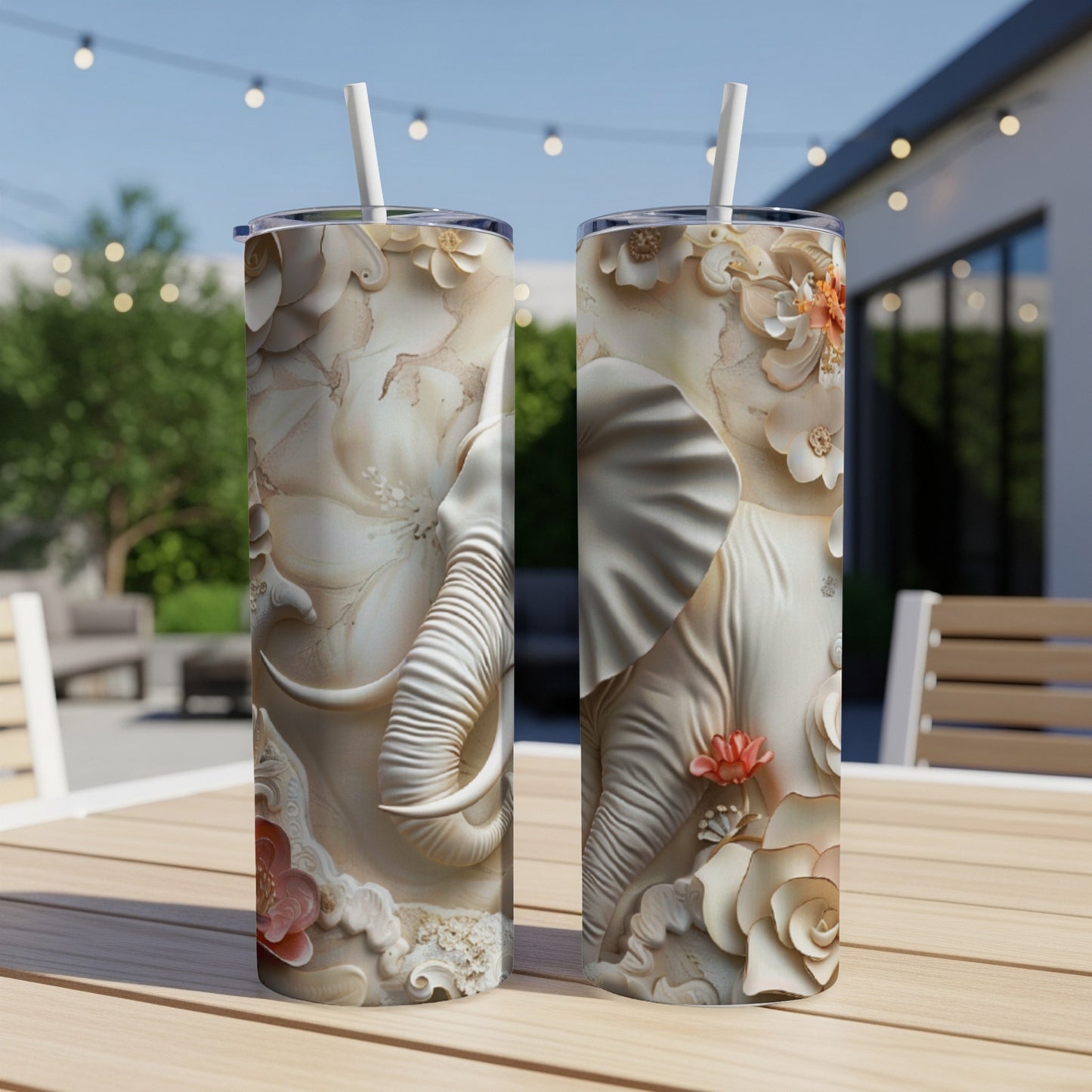 Two white tumblers with embossed elephant and floral designs.