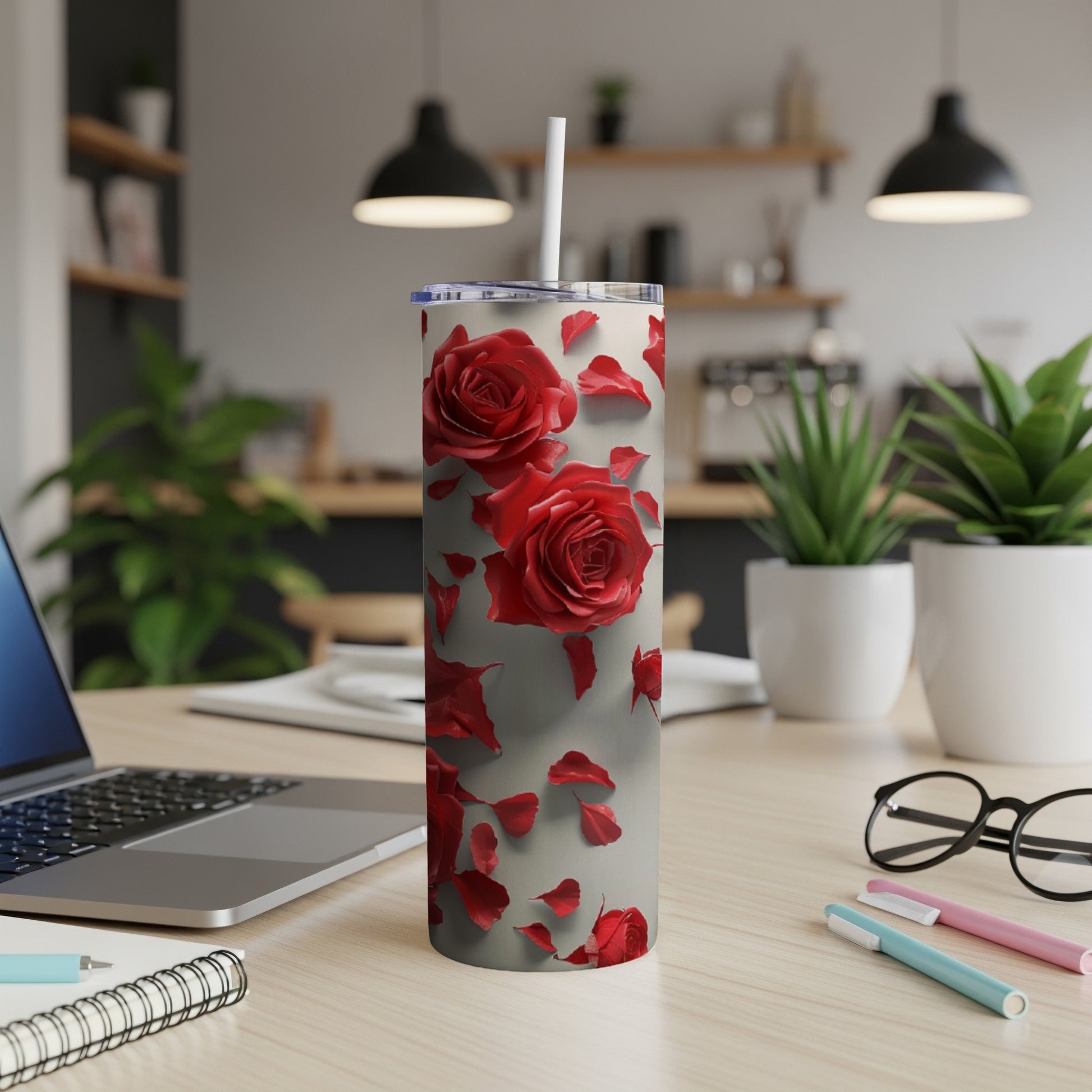 Red roses and petals scattered on a white tumbler with a straw.
