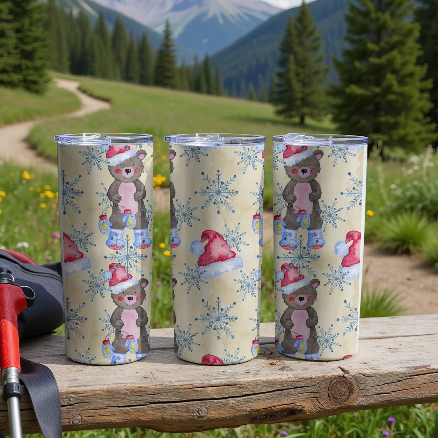 Three Santa hat-wearing bears with snowflakes on a ski resort path.