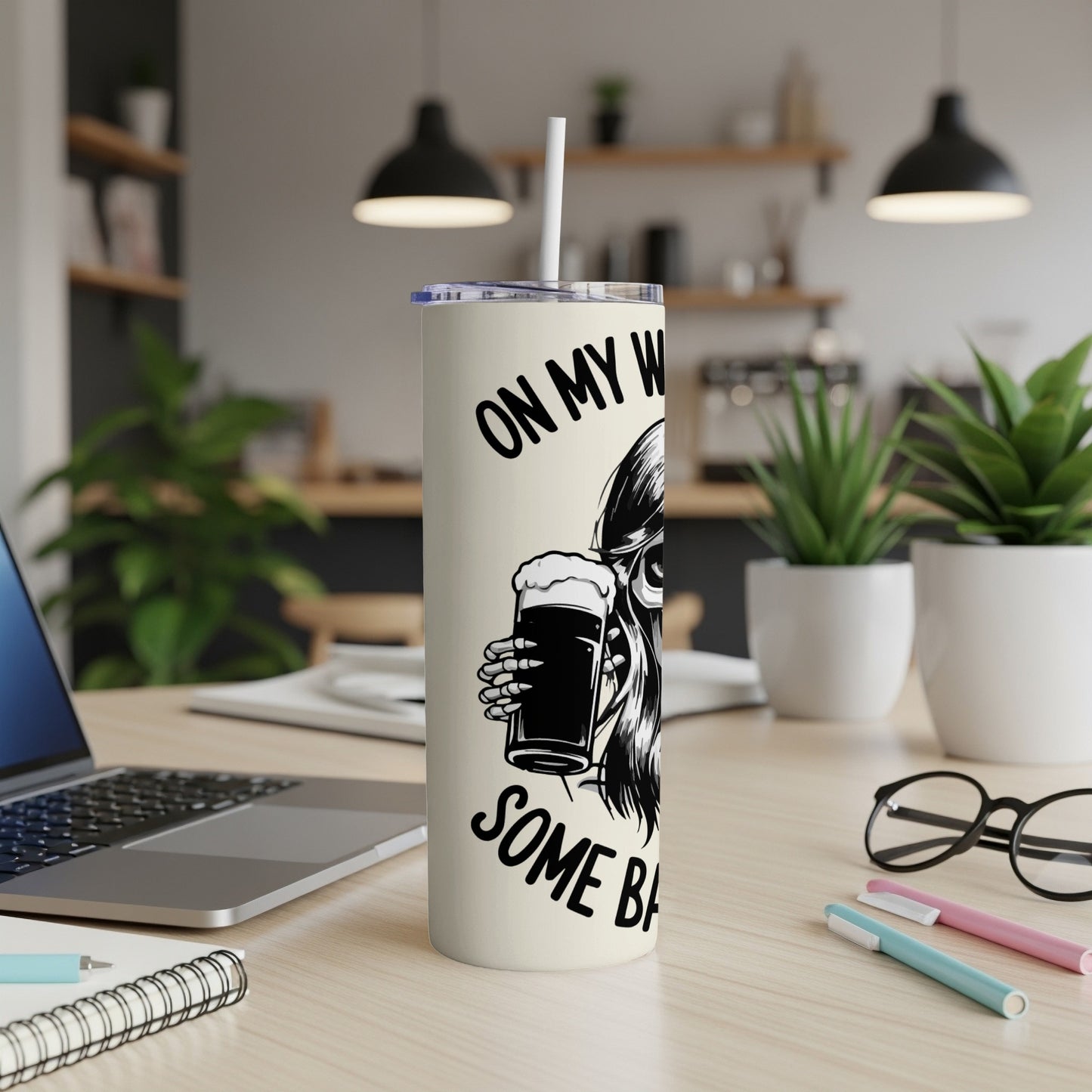 Skeleton holding a beer mug on a tumbler with text.