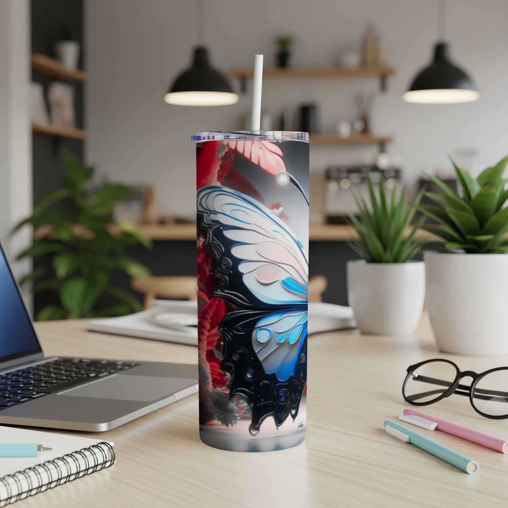 Butterfly design on a white insulated tumbler with a straw.
