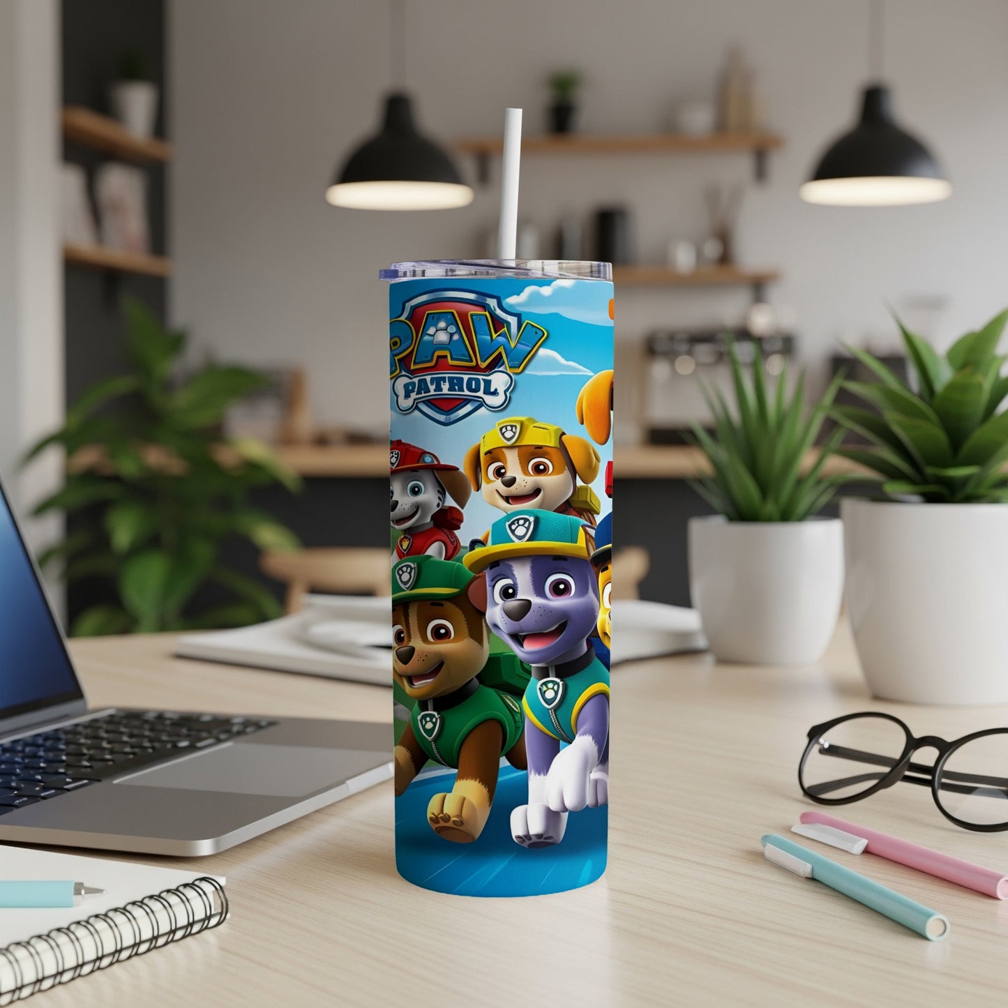 Paw Patrol characters on a blue tumbler with a white straw.