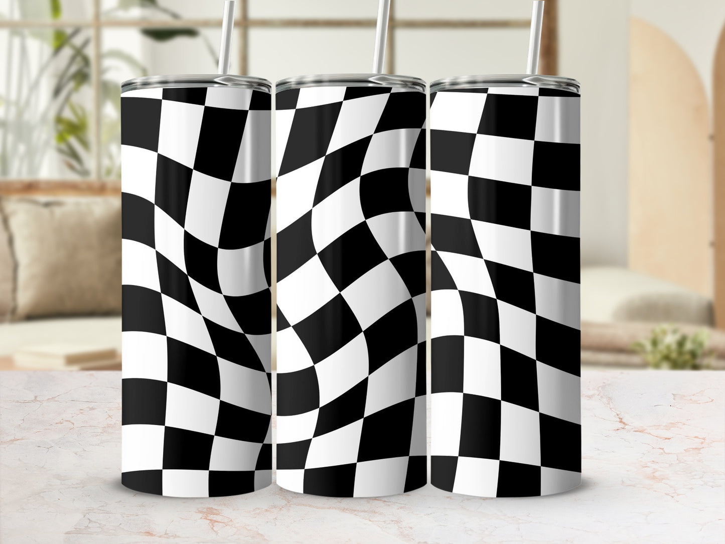Three tumblers with black and white checkered pattern and straws.