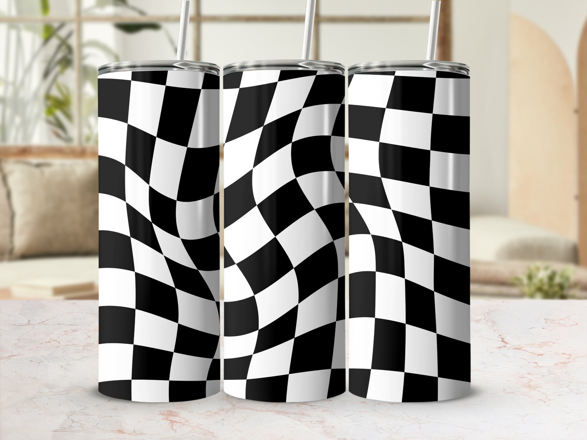 Three tumblers with black and white checkered pattern and straws.
