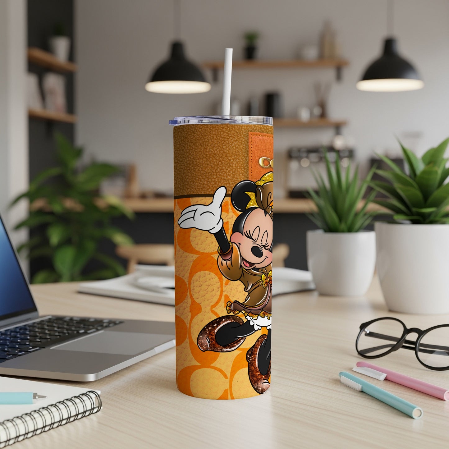 Minnie Mouse tumbler with Coach logo and brown patterned design.