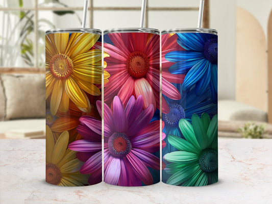 Three tumblers featuring vibrant floral designs in yellow, pink, and blue/green.