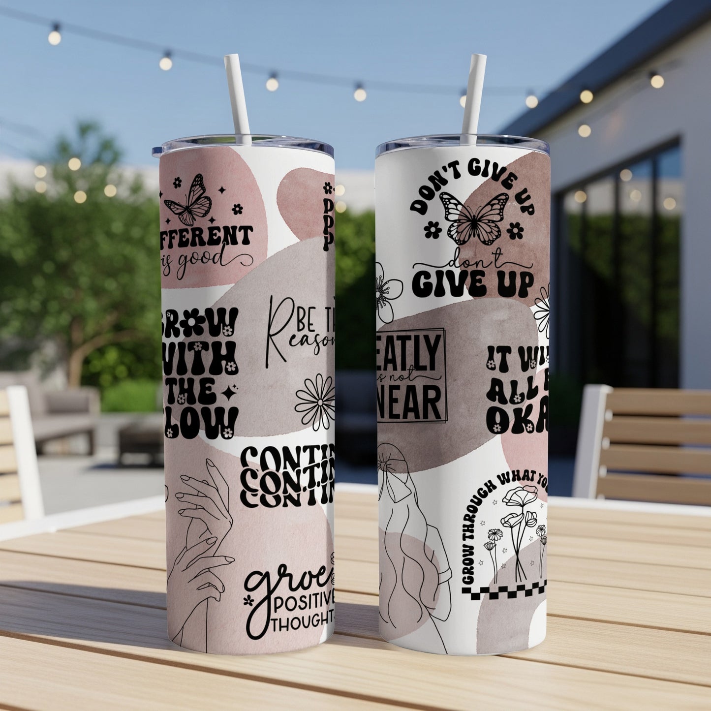 Two tumblers with inspirational quotes and floral designs.