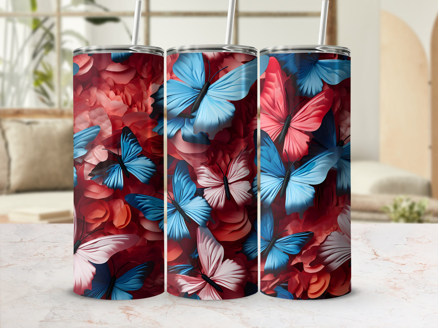 Three tumblers with a pink and blue butterfly and floral design.