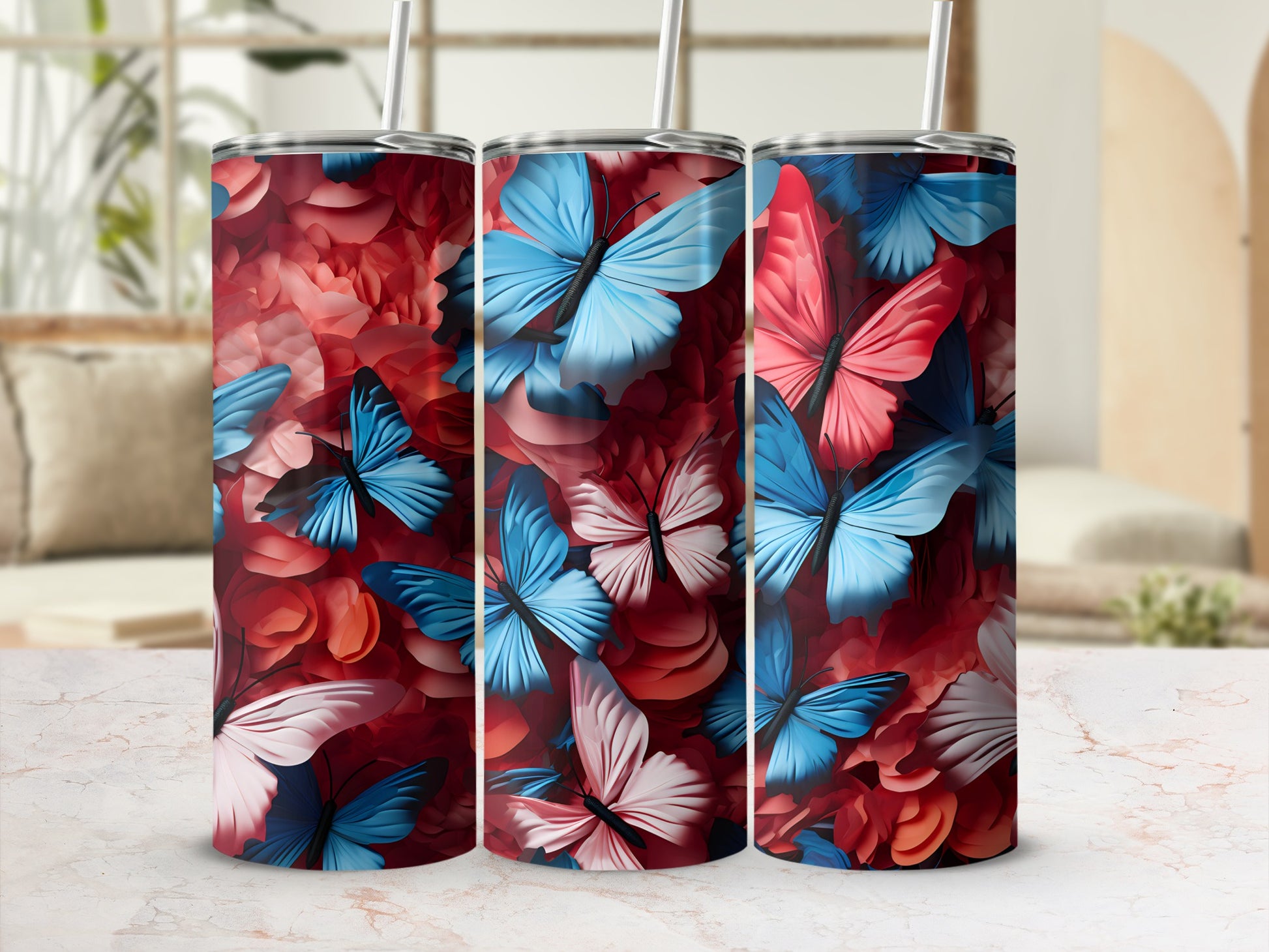 Three tumblers with a pink and blue butterfly and floral design.