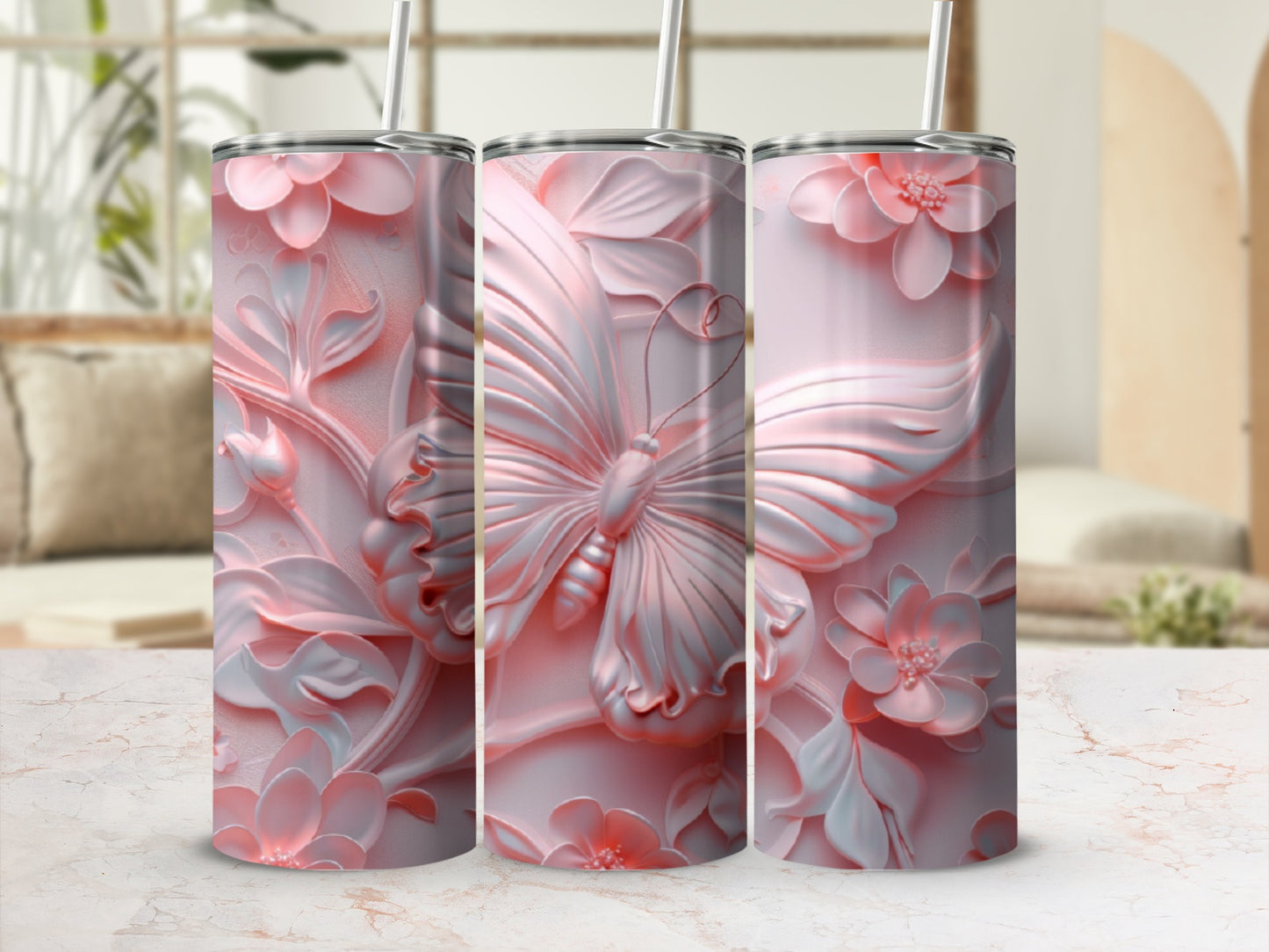 Pink butterfly and floral embossed 3-tumbler display with a straw.