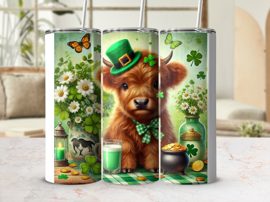 Fluffy highland calf in green hat with shamrocks and butterflies on tumbler.