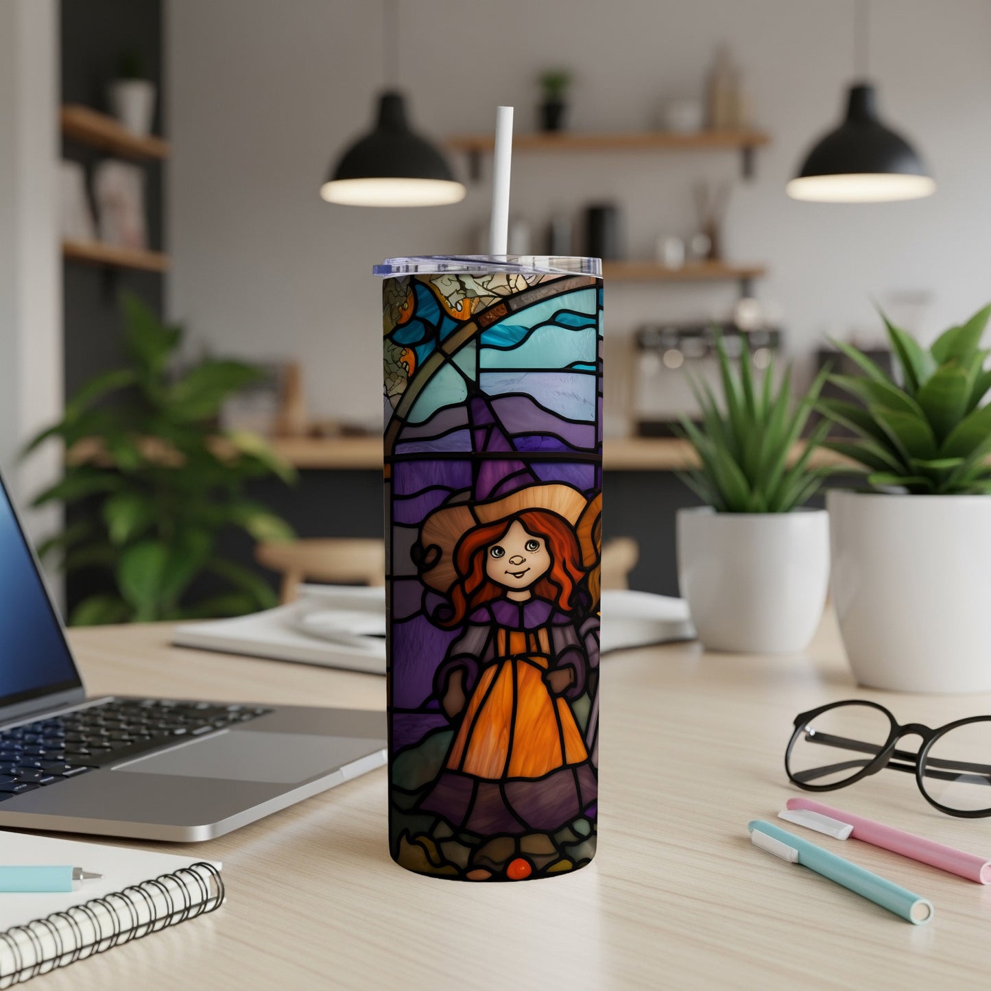Stained glass tumbler with a witch and floral design.