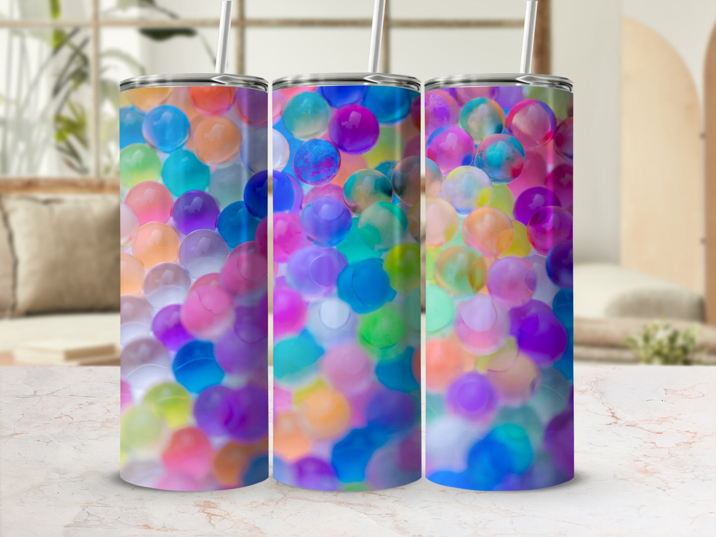 Three tumblers with colorful, translucent bead patterns.