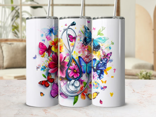Three white tumblers with colorful butterflies and floral designs, one with a stethoscope.