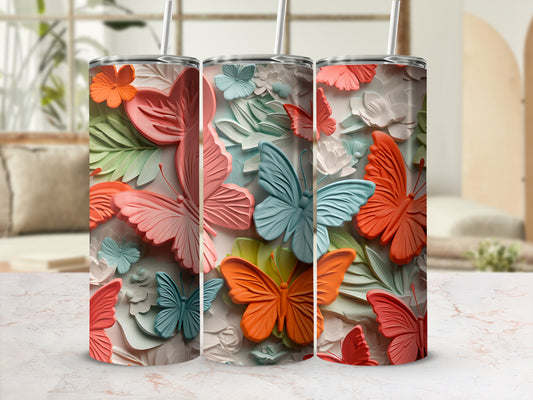Three colorful butterfly tumblers with floral and leaf accents.