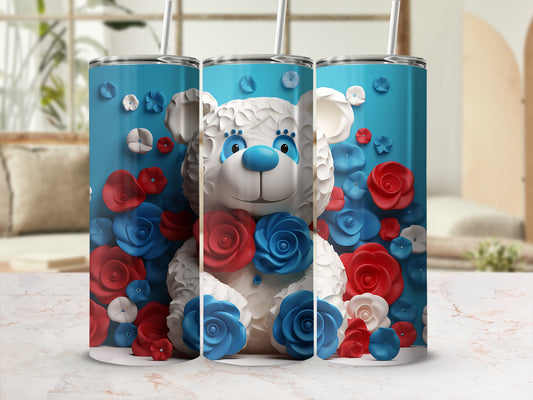 Blue, white, and red teddy bear surrounded by floral accents on a blue background.