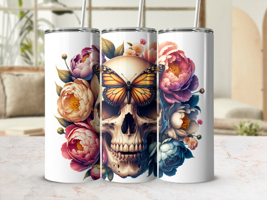 Skull with butterfly, surrounded by colorful flowers on a tumbler.