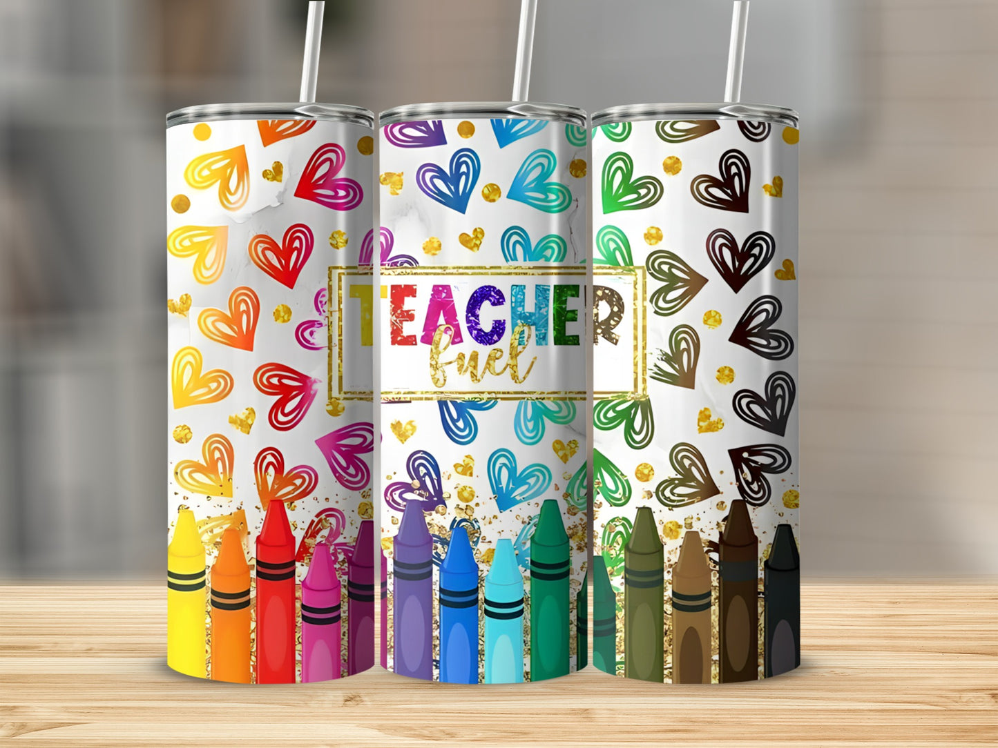 Three tumblers with colorful crayon and heart designs, one saying "Teacher Fuel."