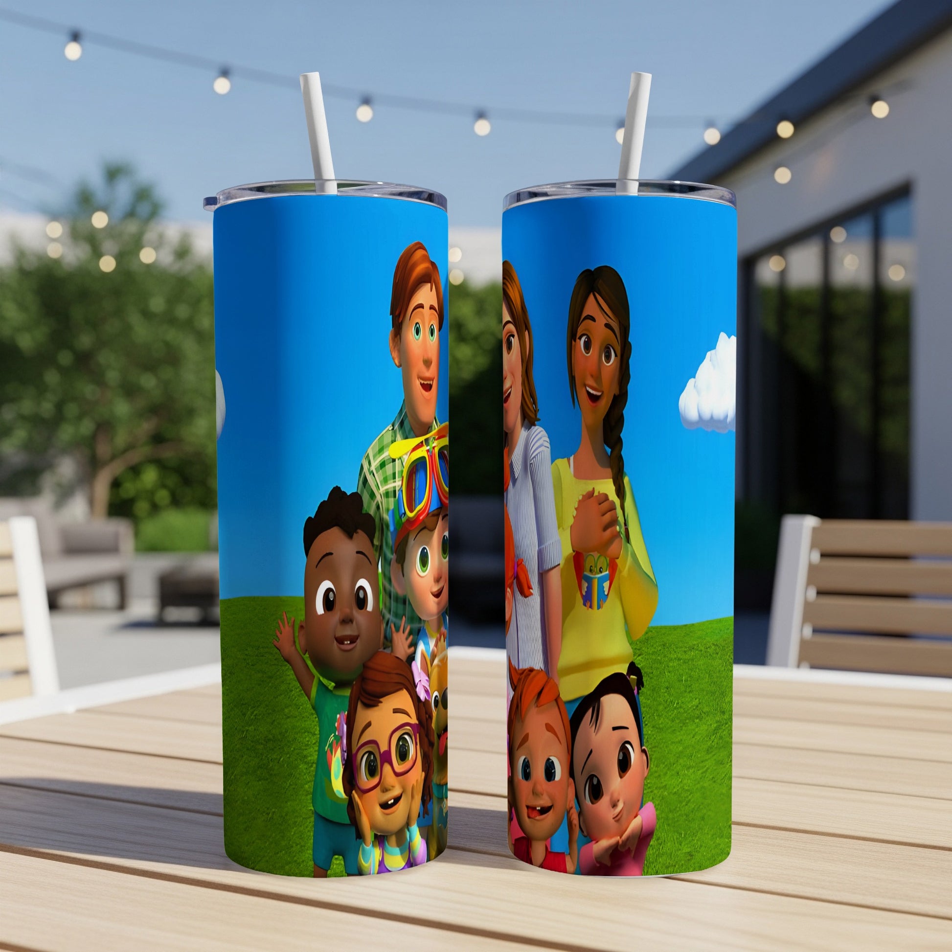 Cocomelon characters on two white tumblers with straws, on a table.