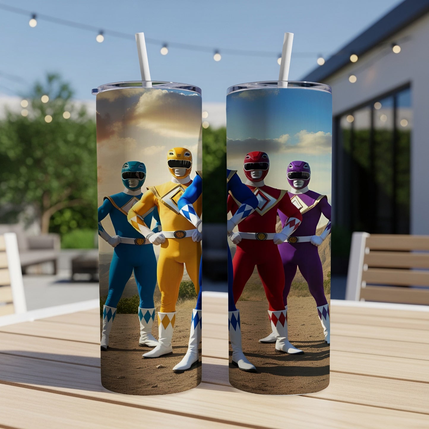 Two Power Rangers tumblers stand on a table, featuring Blue, Yellow, Red, and Pink Rangers.