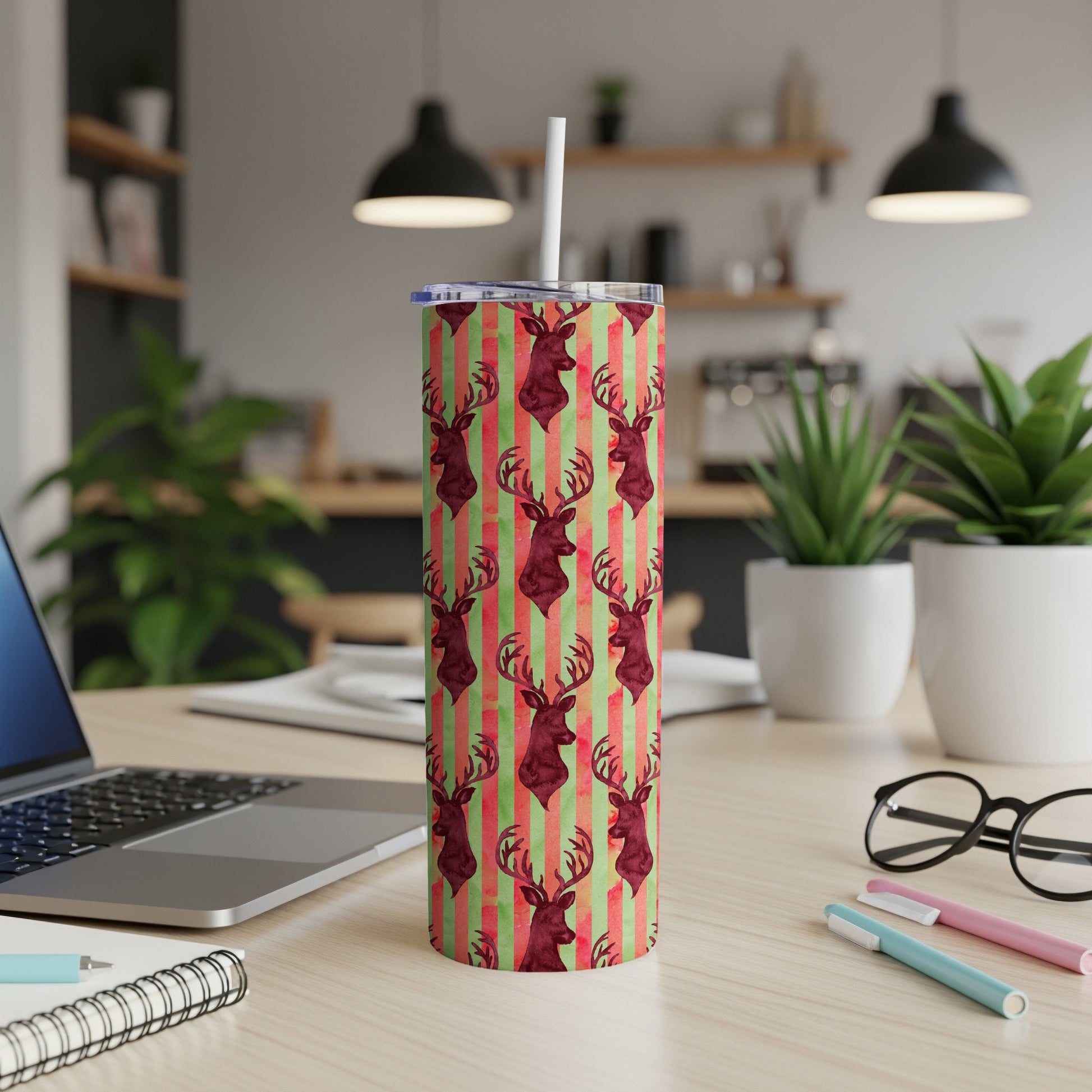 Red and green striped tumbler with repeating deer head pattern.