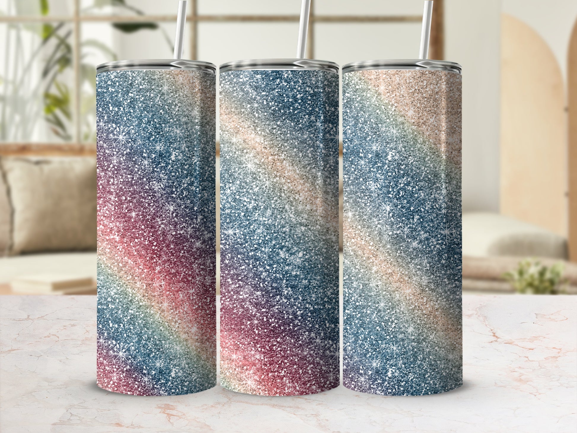 Three glitter tumblers with a diagonal rainbow gradient design and reusable straws.