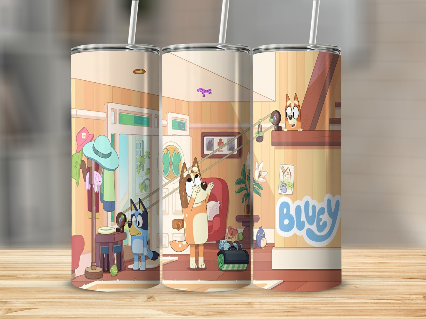 Bluey characters on a tumbler with a floral pattern and a straw.