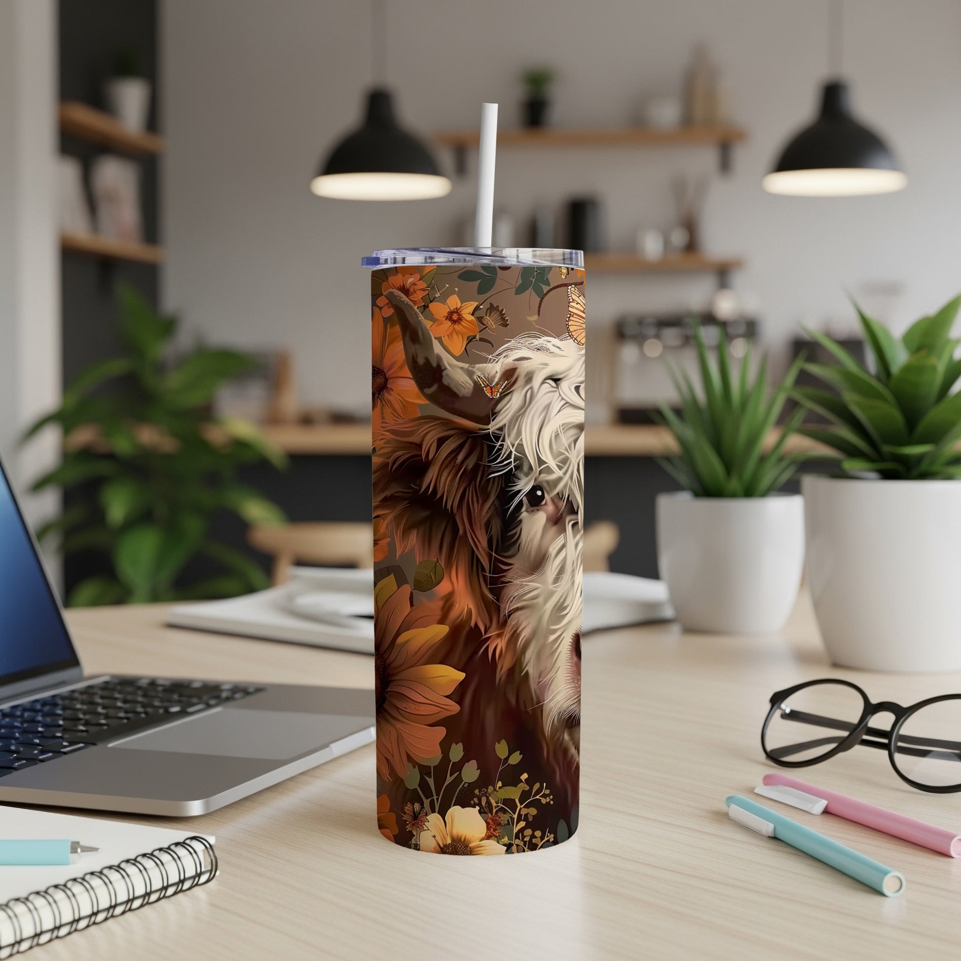 Highland cow with sunflowers design on a stainless steel tumbler.