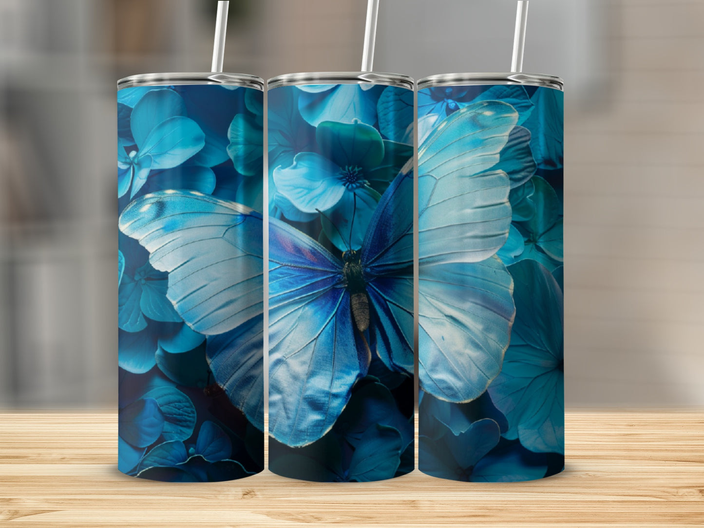 Three blue tumblers with a large blue butterfly and floral pattern.