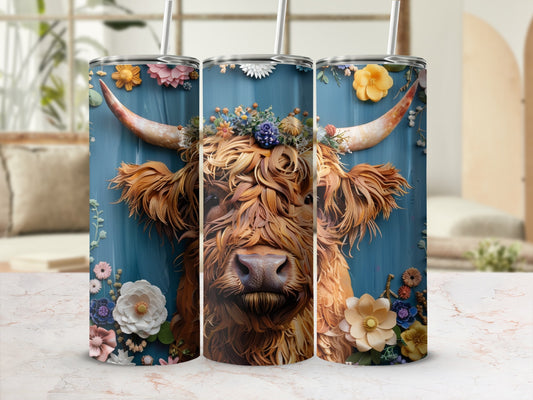 Highland cow with floral crown on blue background, shown on three tumblers.
