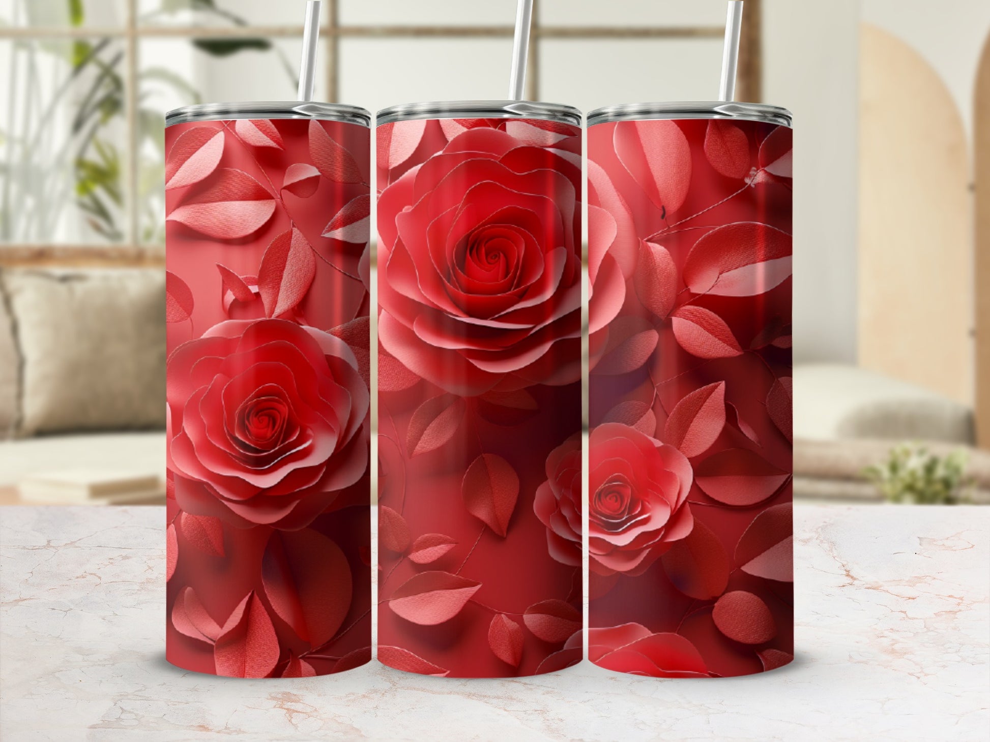Red rose floral pattern on three stainless steel tumblers.