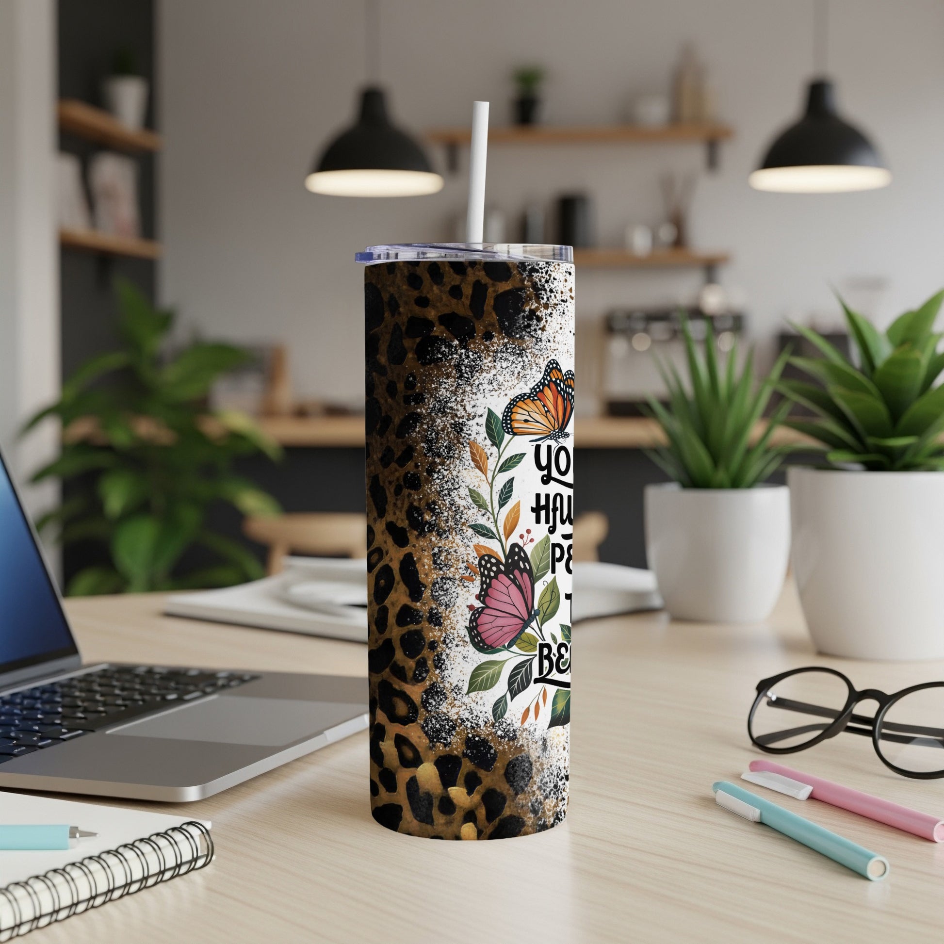 Leopard print tumbler with colorful butterflies and inspirational text.