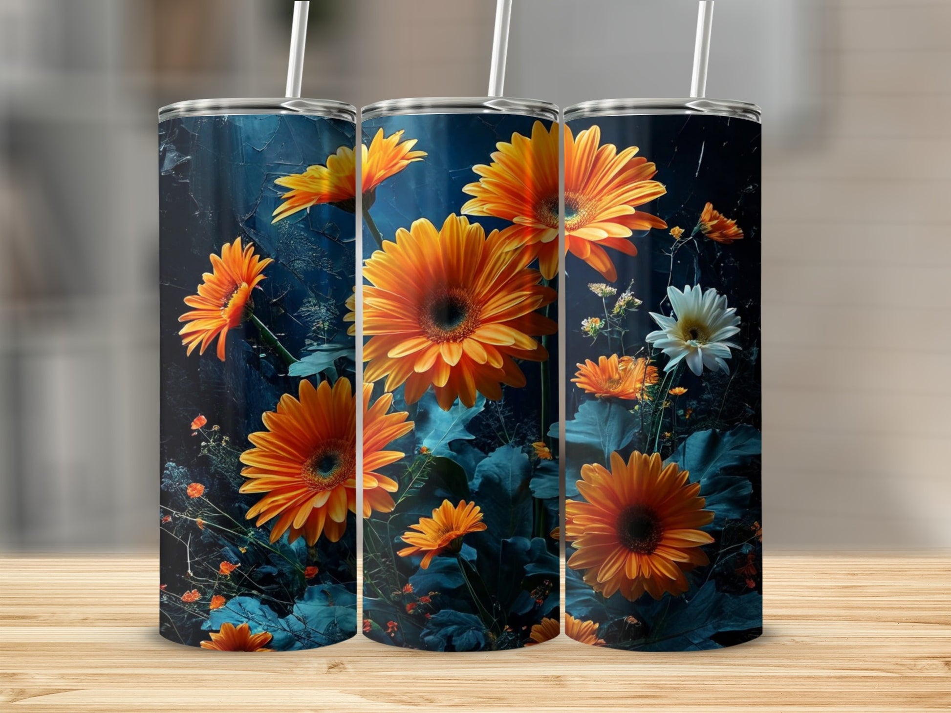 Three tumblers with vibrant orange gerbera daisies and dark blue floral background.