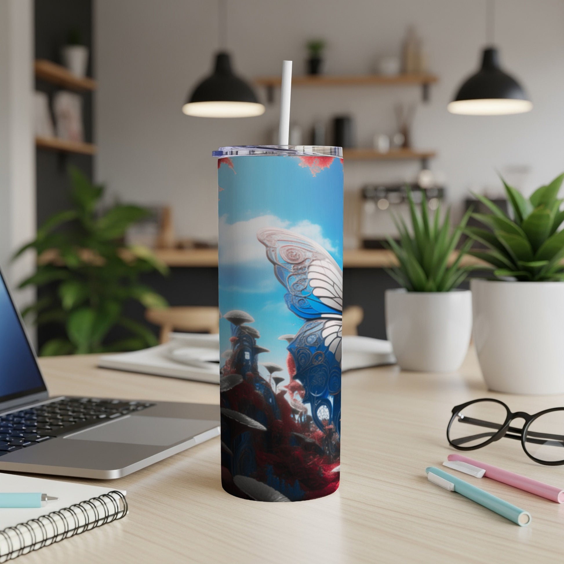 Butterfly wings and mushrooms design on a blue and red tumbler with white straw.