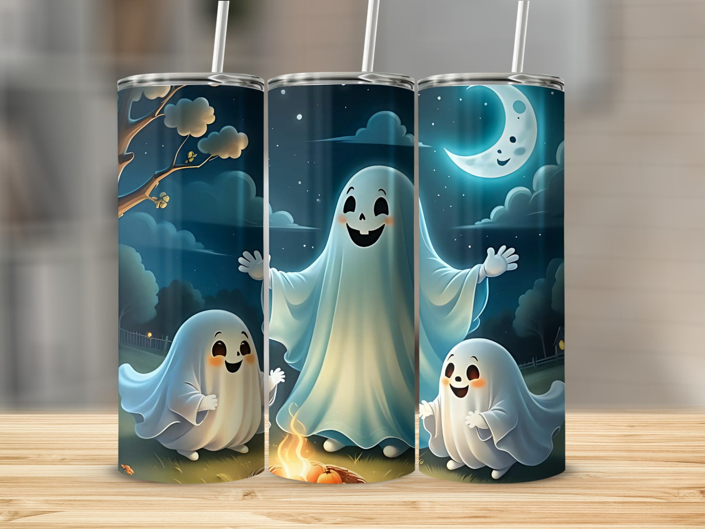 Three tumblers with a whimsical Halloween ghost design under a crescent moon.