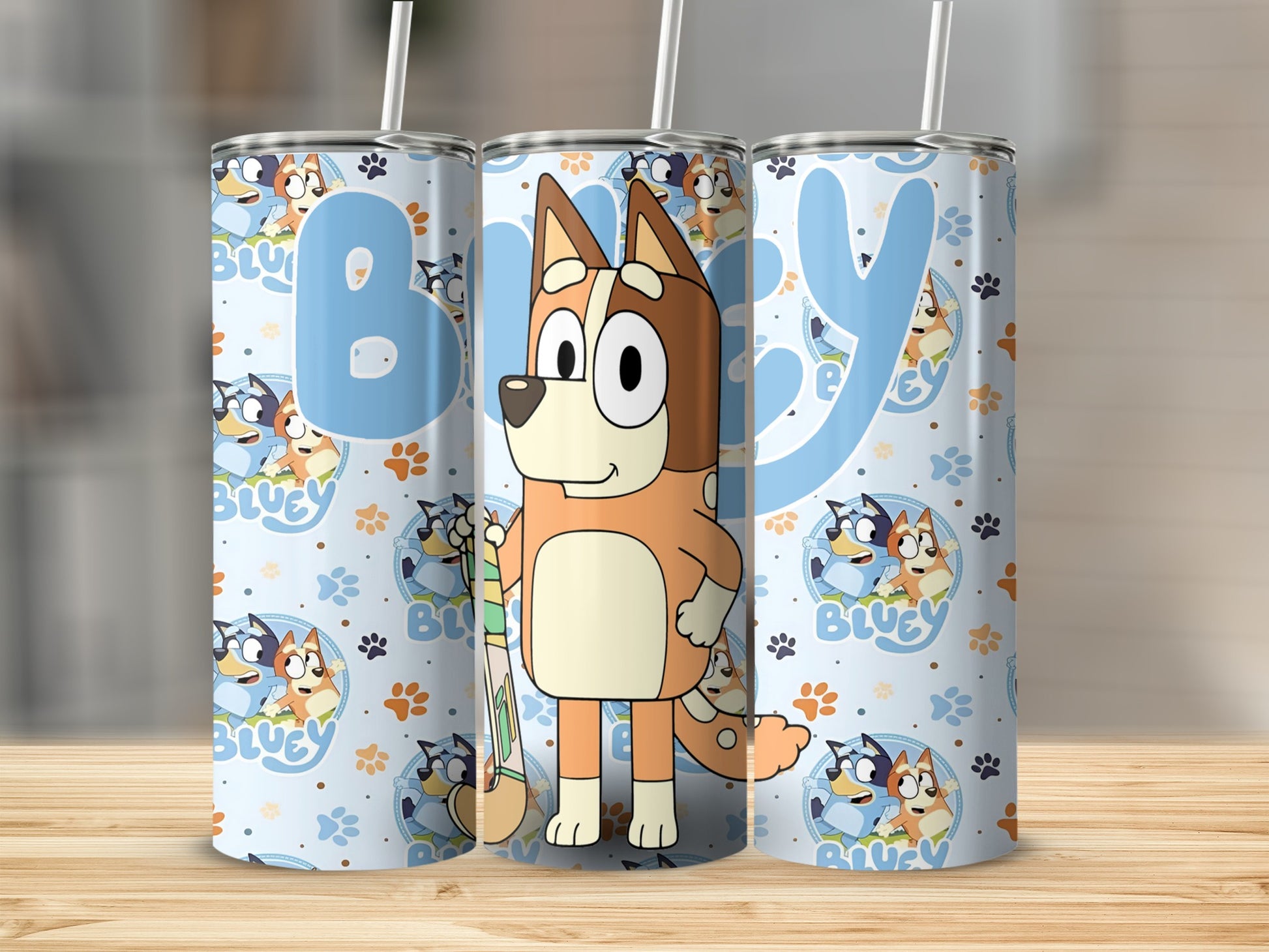 Bluey character on light blue tumbler with paw print pattern.