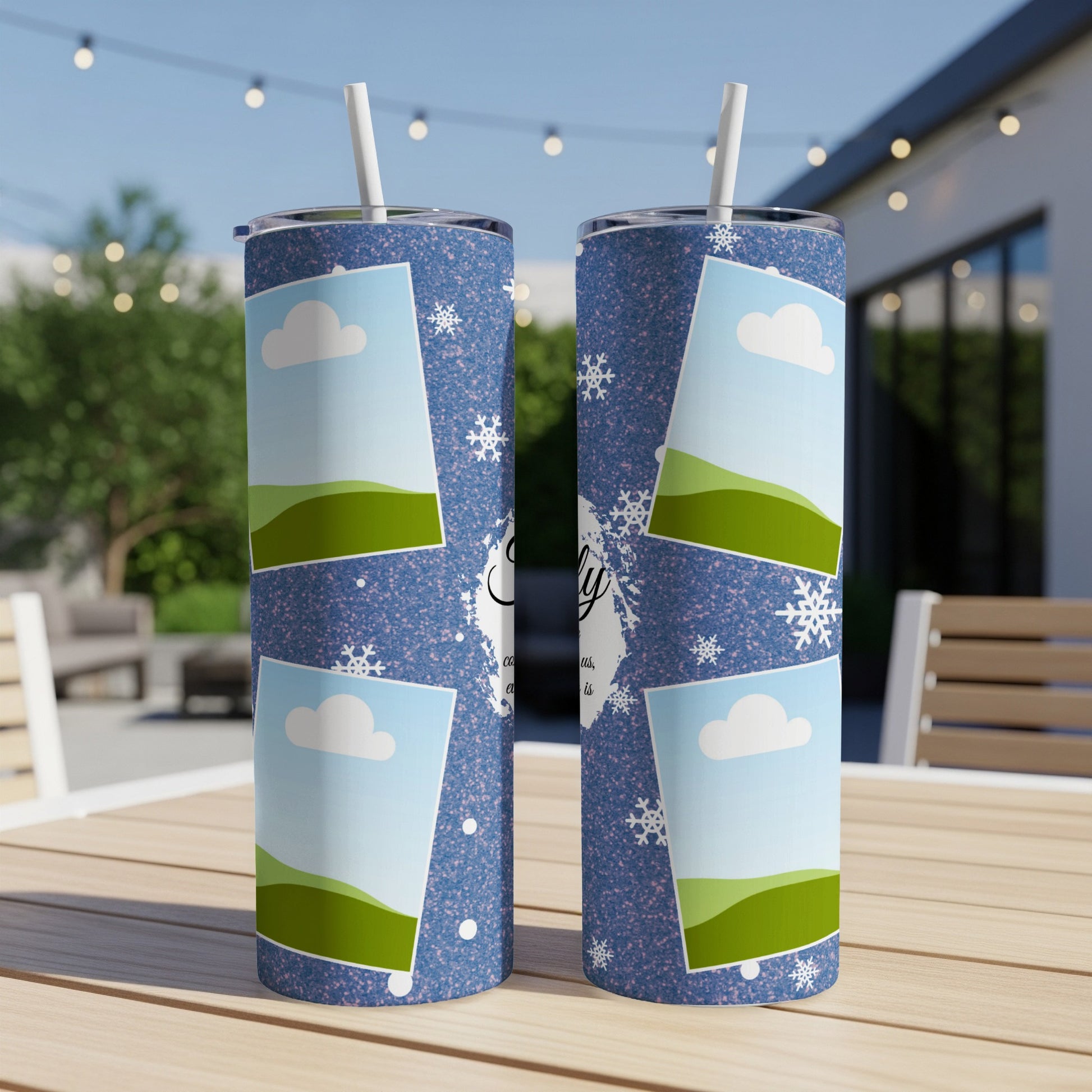 Two blue speckled tumblers with snowflake, cloud, and landscape photo frames.