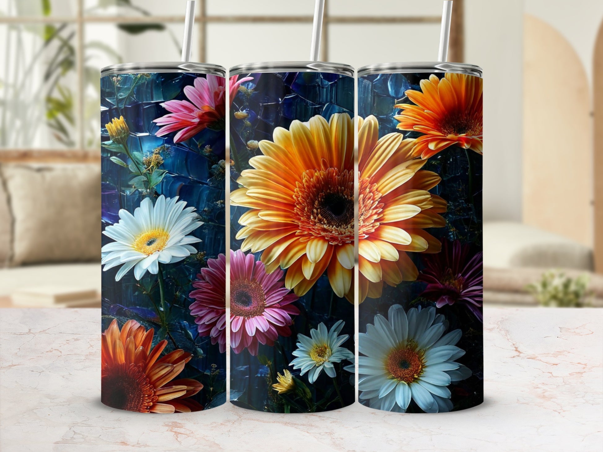 Three tumblers with vibrant floral designs, featuring daisies and sunflowers.