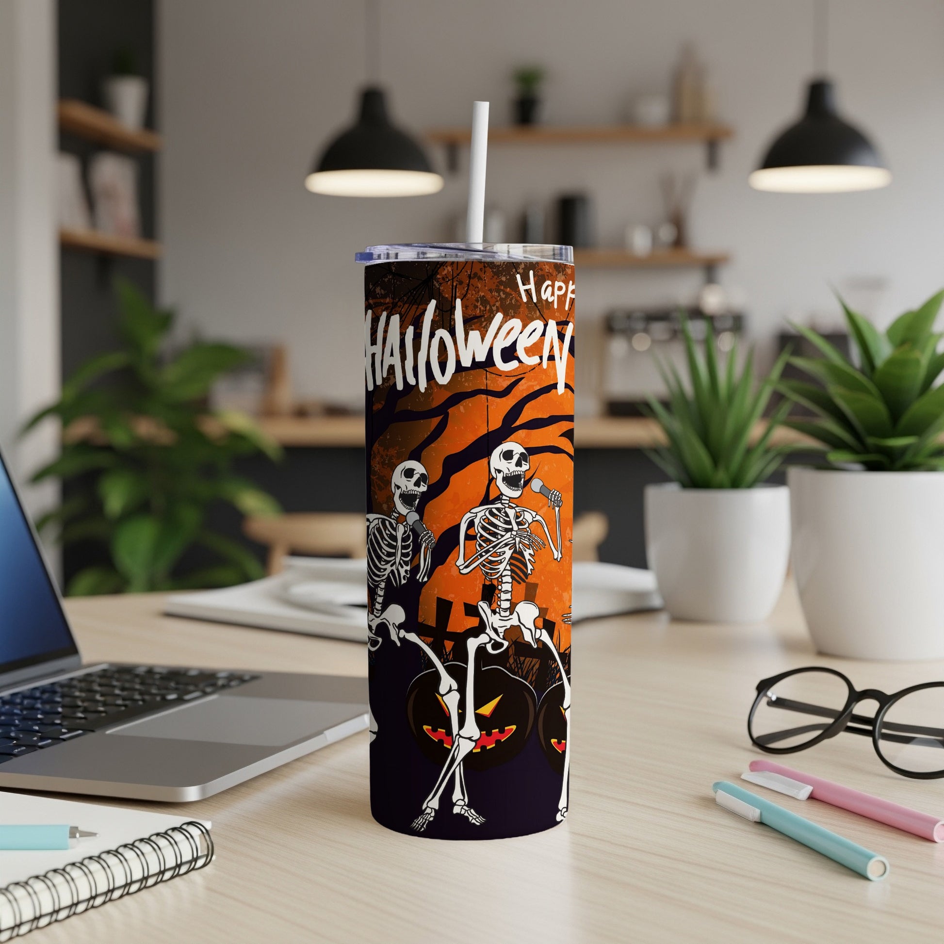 Tumbler with skeletons singing and pumpkins, says "Happy Halloween"