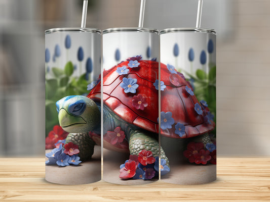 Red turtle adorned with blue and red flowers, displayed on three tumblers.