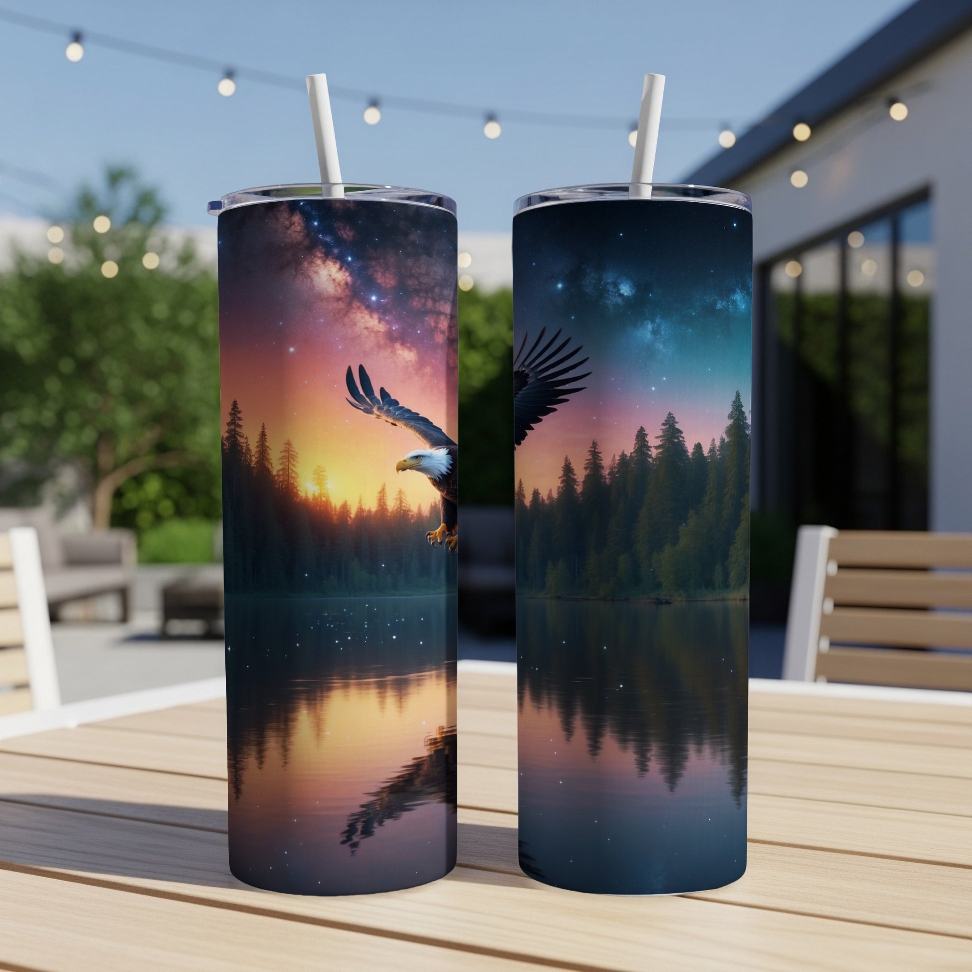 Two tumblers with an eagle in flight over a lake and forest at sunset.