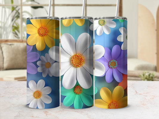 Three tumblers with colorful daisy patterns displayed on a surface.