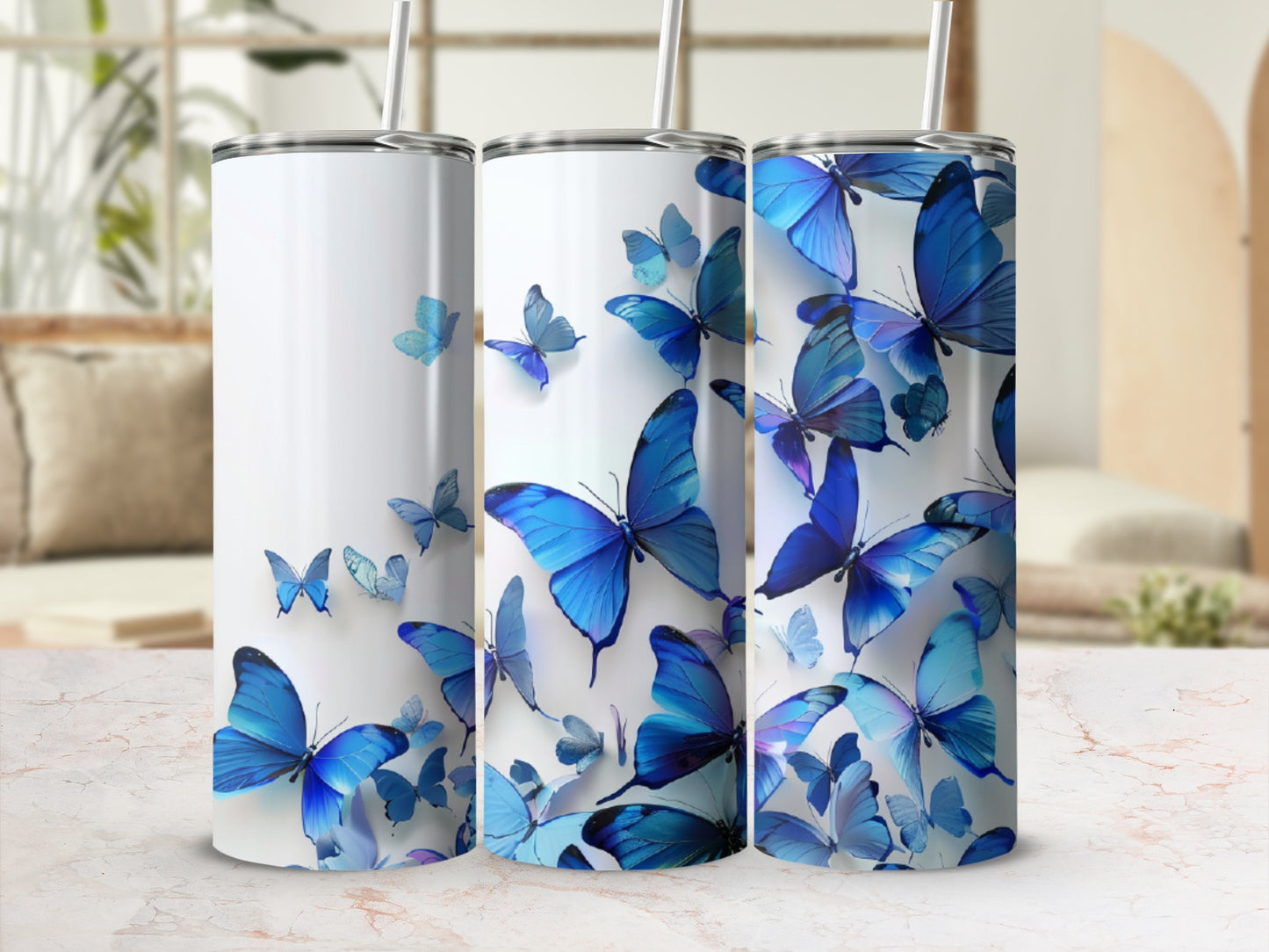 Three white tumblers adorned with blue butterflies in various sizes and orientations.
