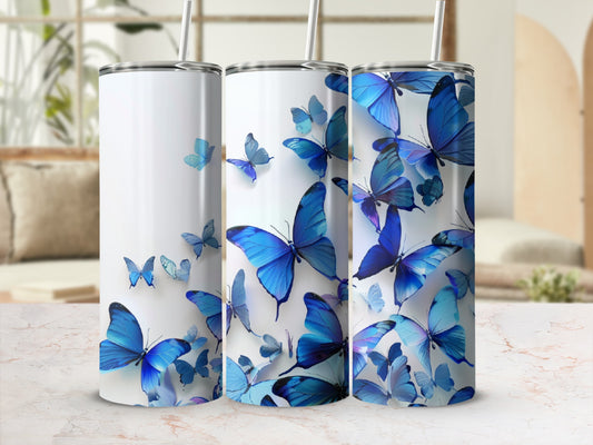 Three white tumblers adorned with blue butterflies in various sizes and orientations.