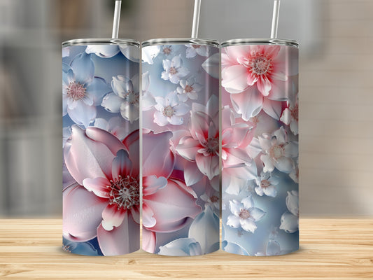 Three floral tumblers with pink and white blossoms on a light blue background.