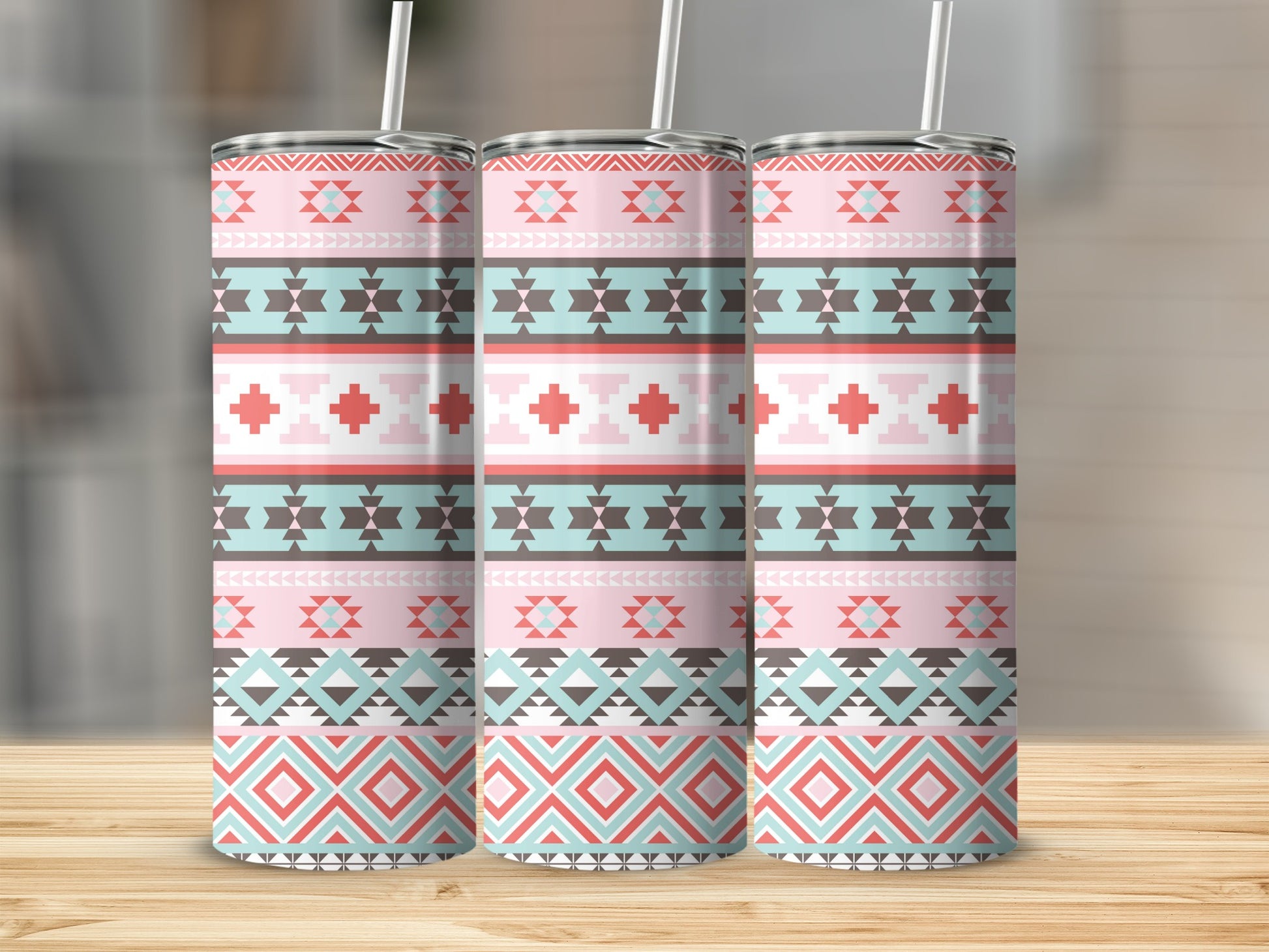 Three tumblers with a pink, teal, coral, and gray geometric tribal pattern.
