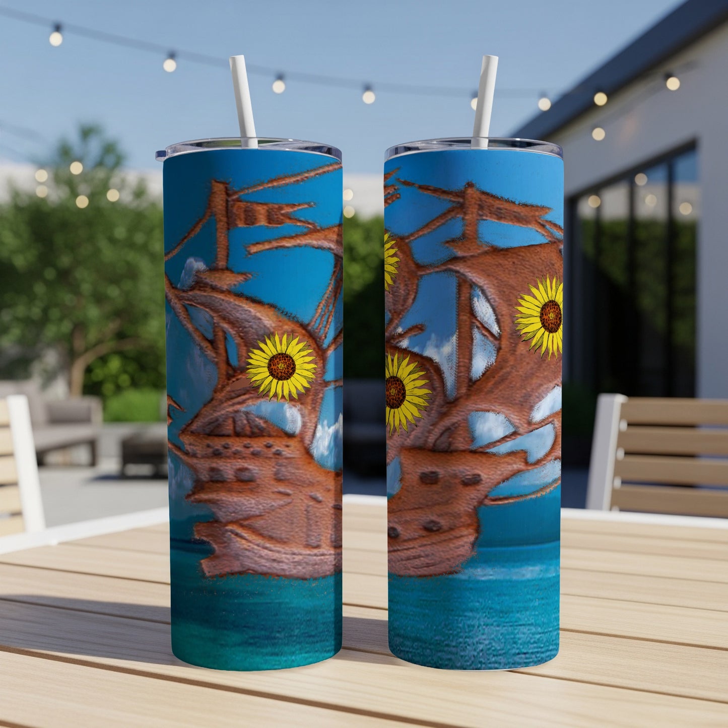 Two tall tumblers featuring a pirate ship with sunflowers against a blue sky.