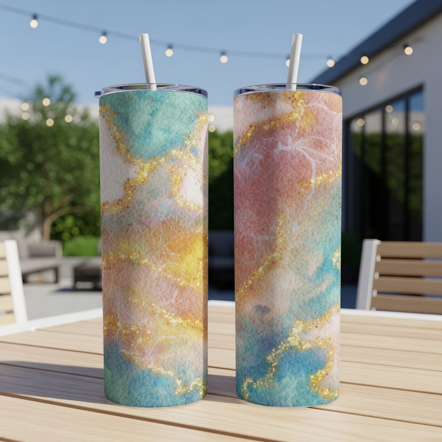 Two tumblers with marble watercolor designs and gold glitter accents.