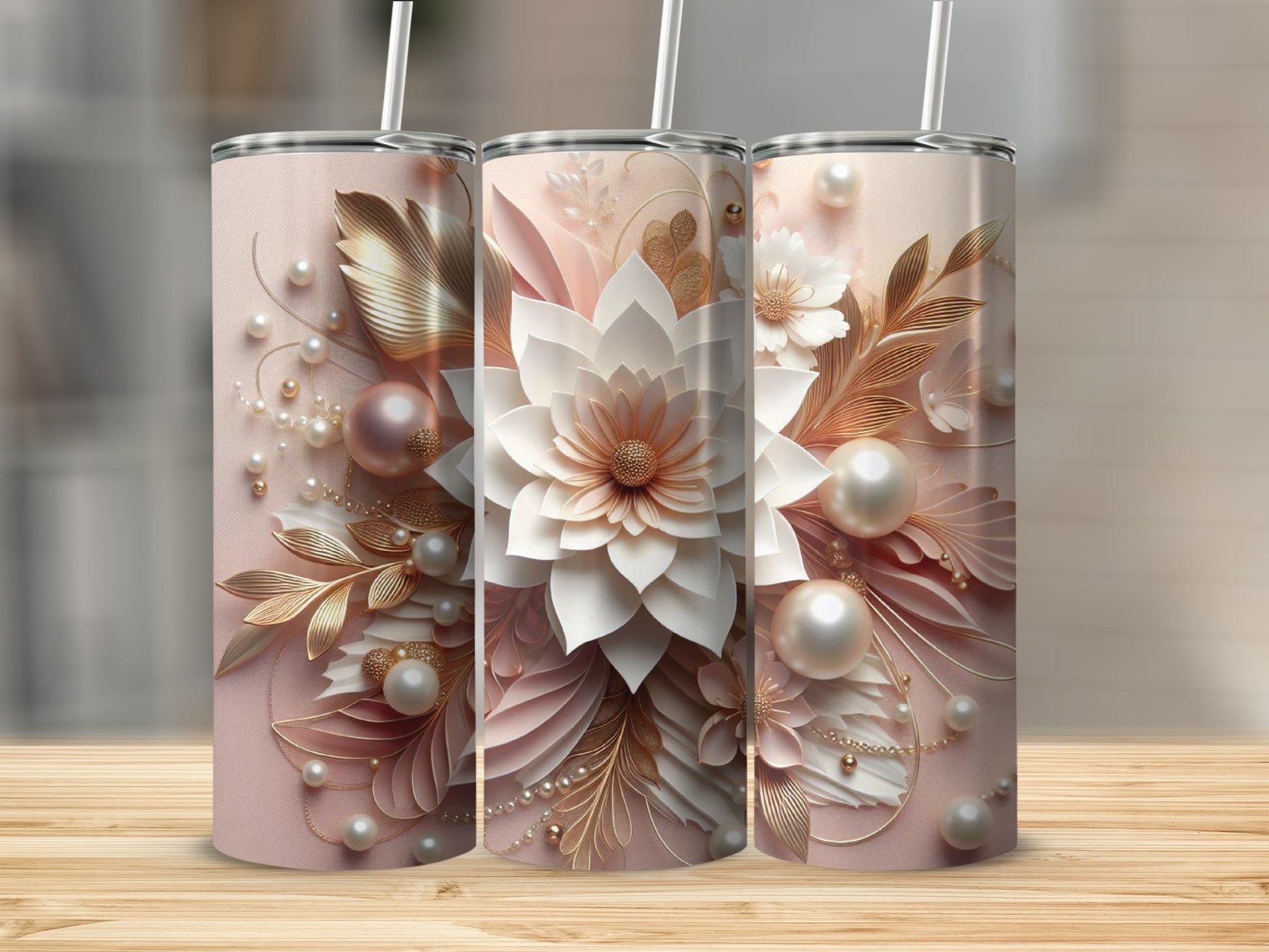 Three pink tumblers with intricate floral and pearl embellishments.